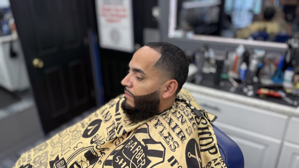 Detailed haircut with lineup and beard blend.