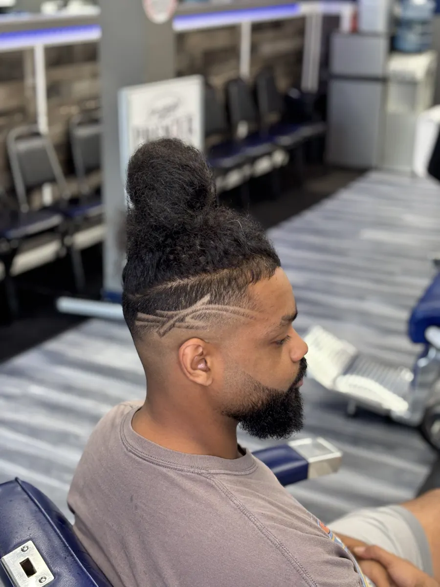 Client with a detailed side design and fade haircut.