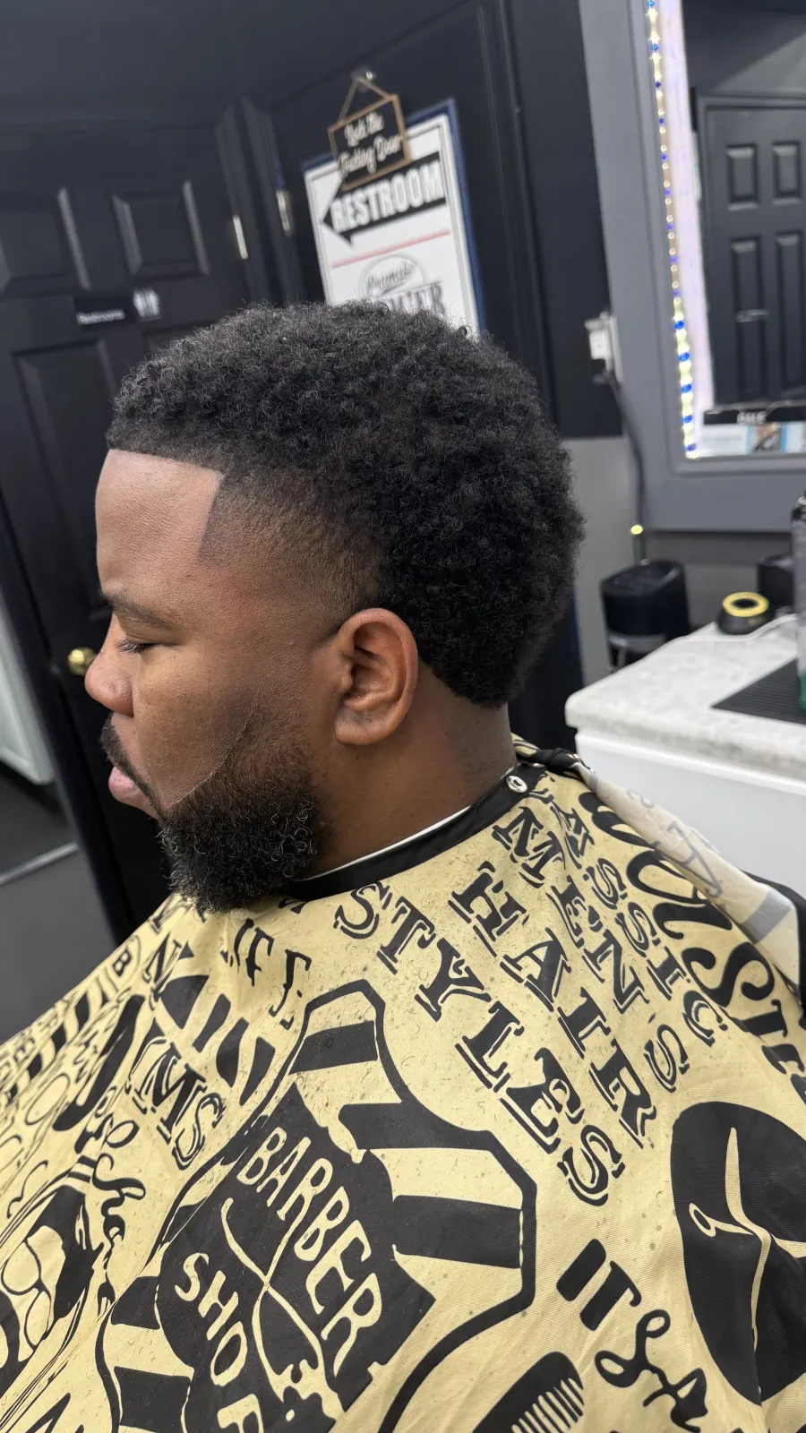 Client side profile showing taper fade and sharp line-up.