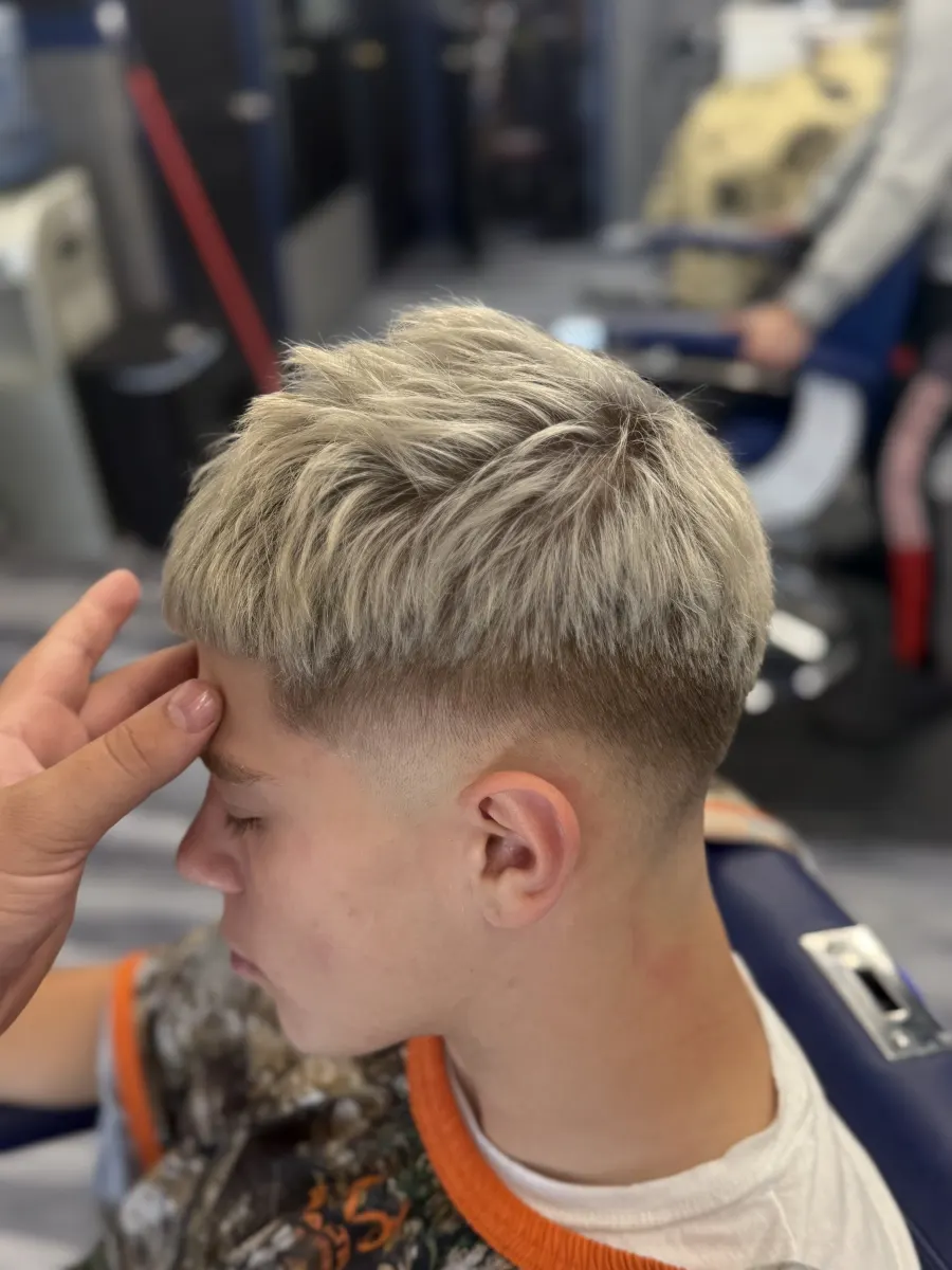 Teen client with a modern textured haircut and fade.