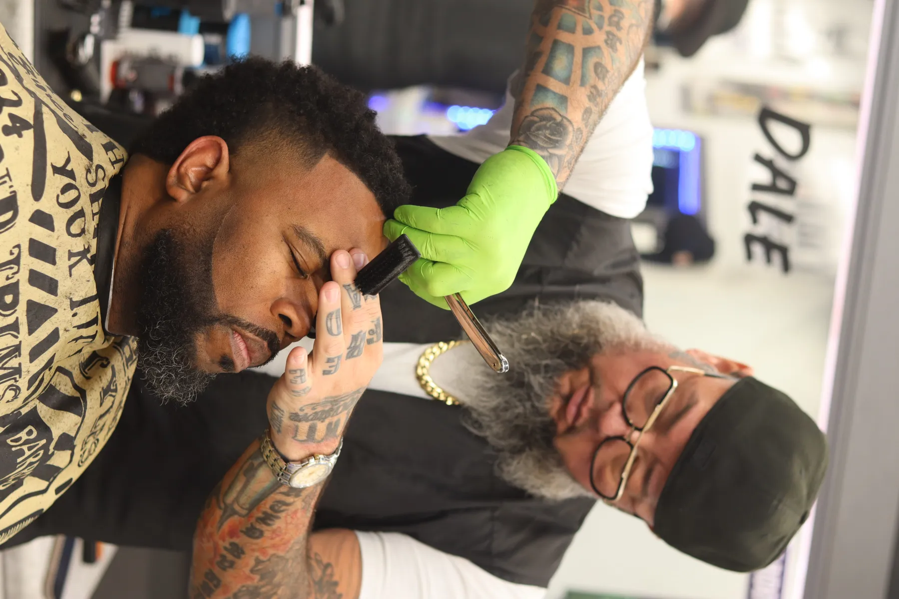 Barber working on a client at Parma's Premier Barber Lounge.