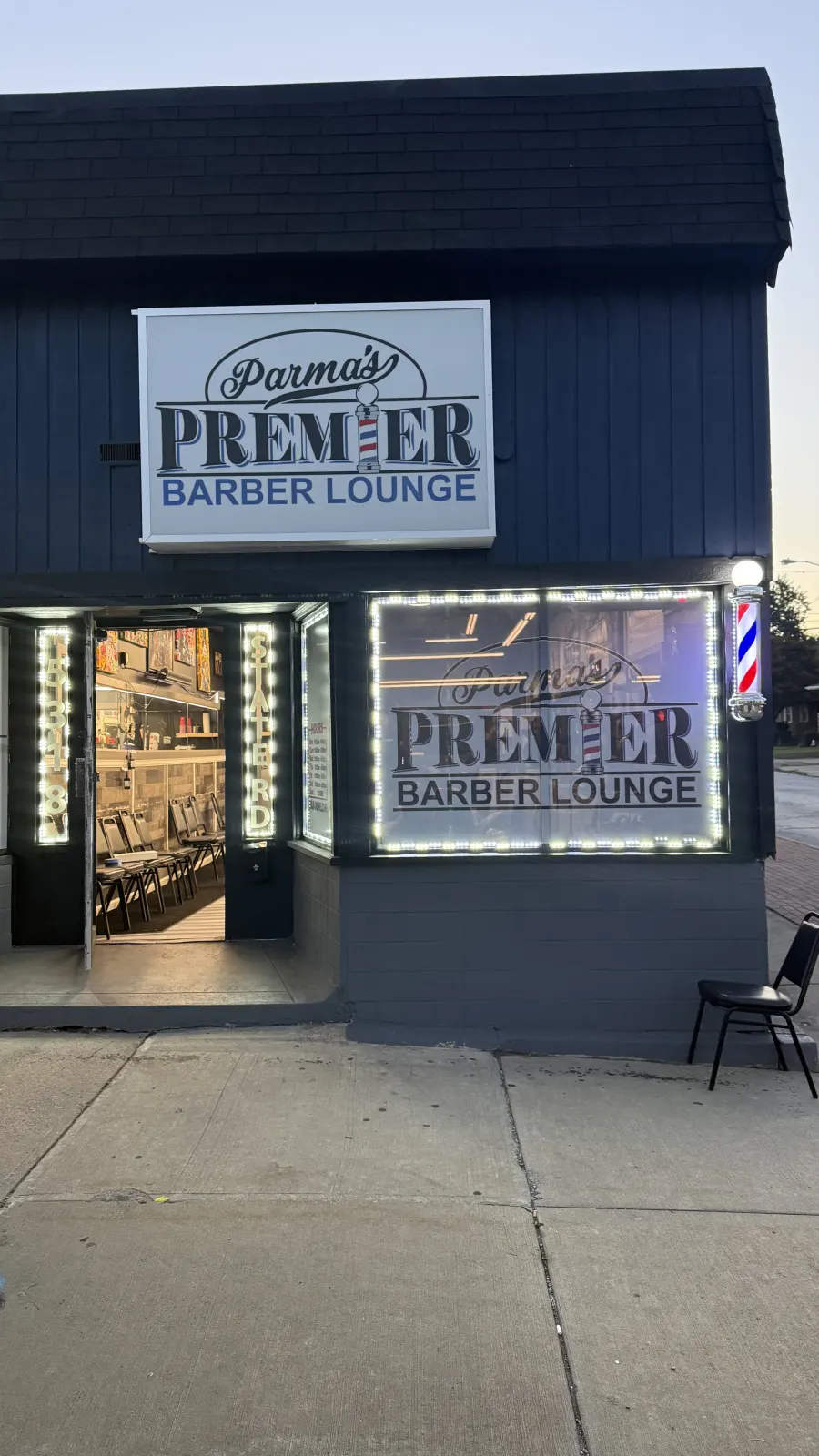 Front view of Parma's Premier Barber Lounge storefront on State Road.